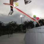 Jose Castillo, young skater, kick-flips off ledge at Westwind Lakes Skatepark