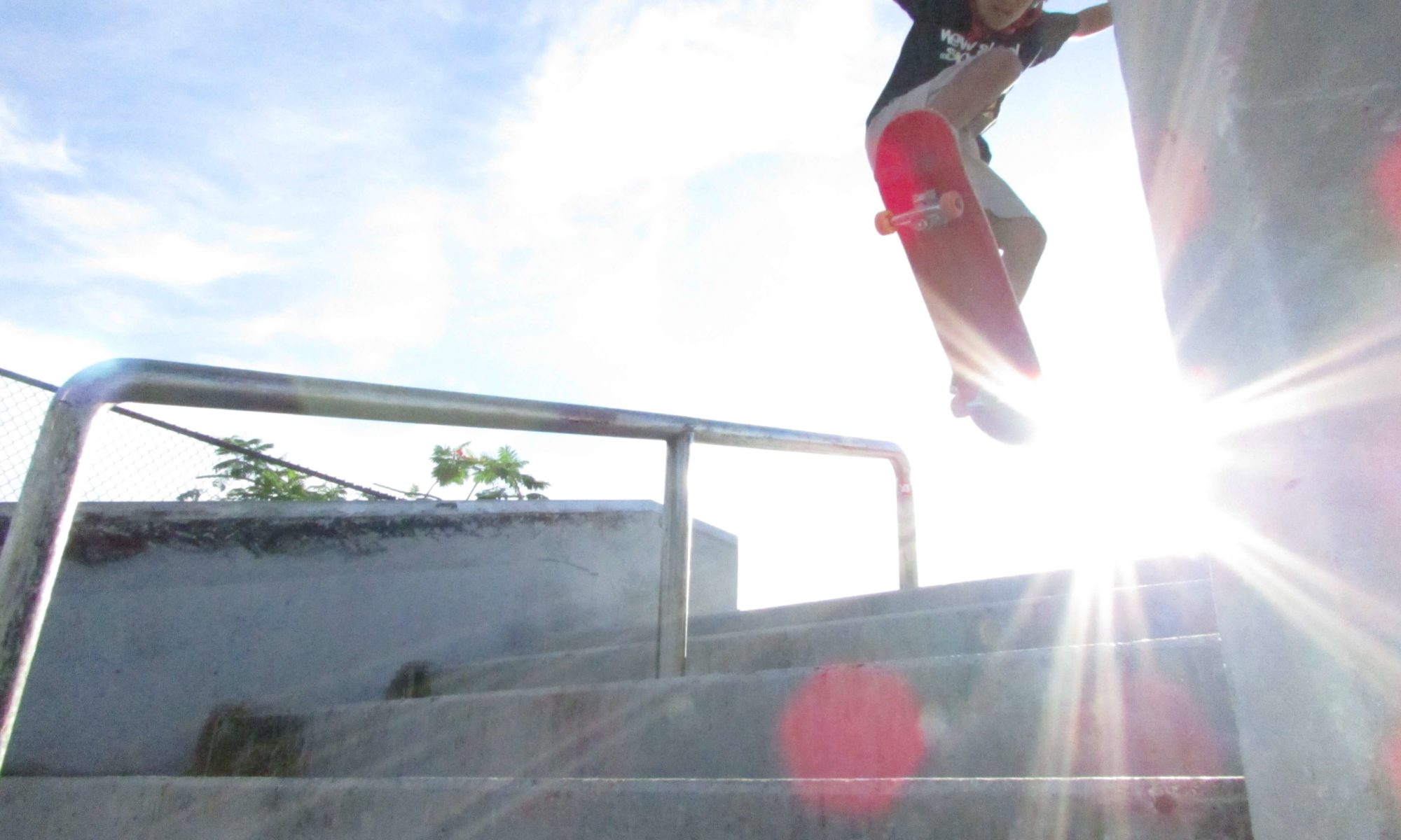 Jose, young skater, ollies a 4-stair over the sun 4 at Westwind Lakes Skatepark Miami