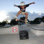 Jose Castillo, young skater, making faces while he ollies the crate, Westwind Lakes Skatepark